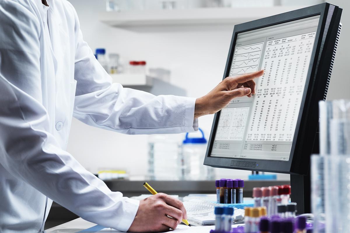 Physician or health care professional reviewing patient lab results on a computer desktop