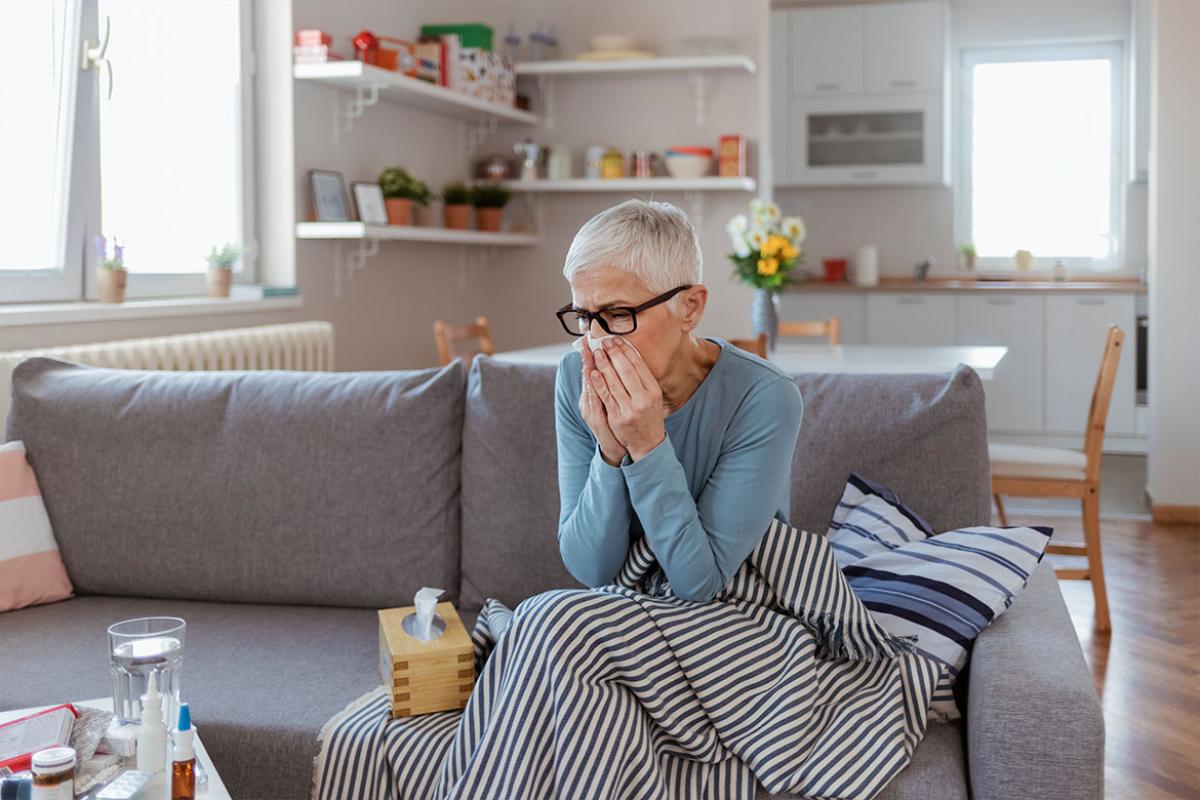 Sitting person holding a tissue to their face