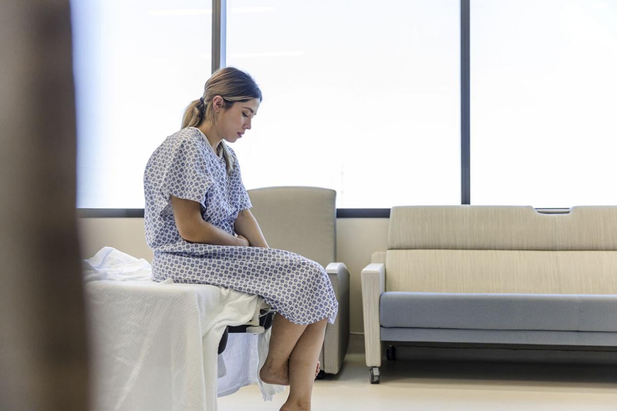 Patient sitting in an empty examination room