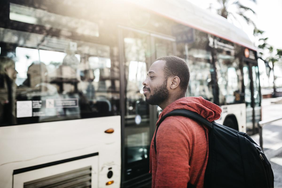 Young man in the city waiting for the bus