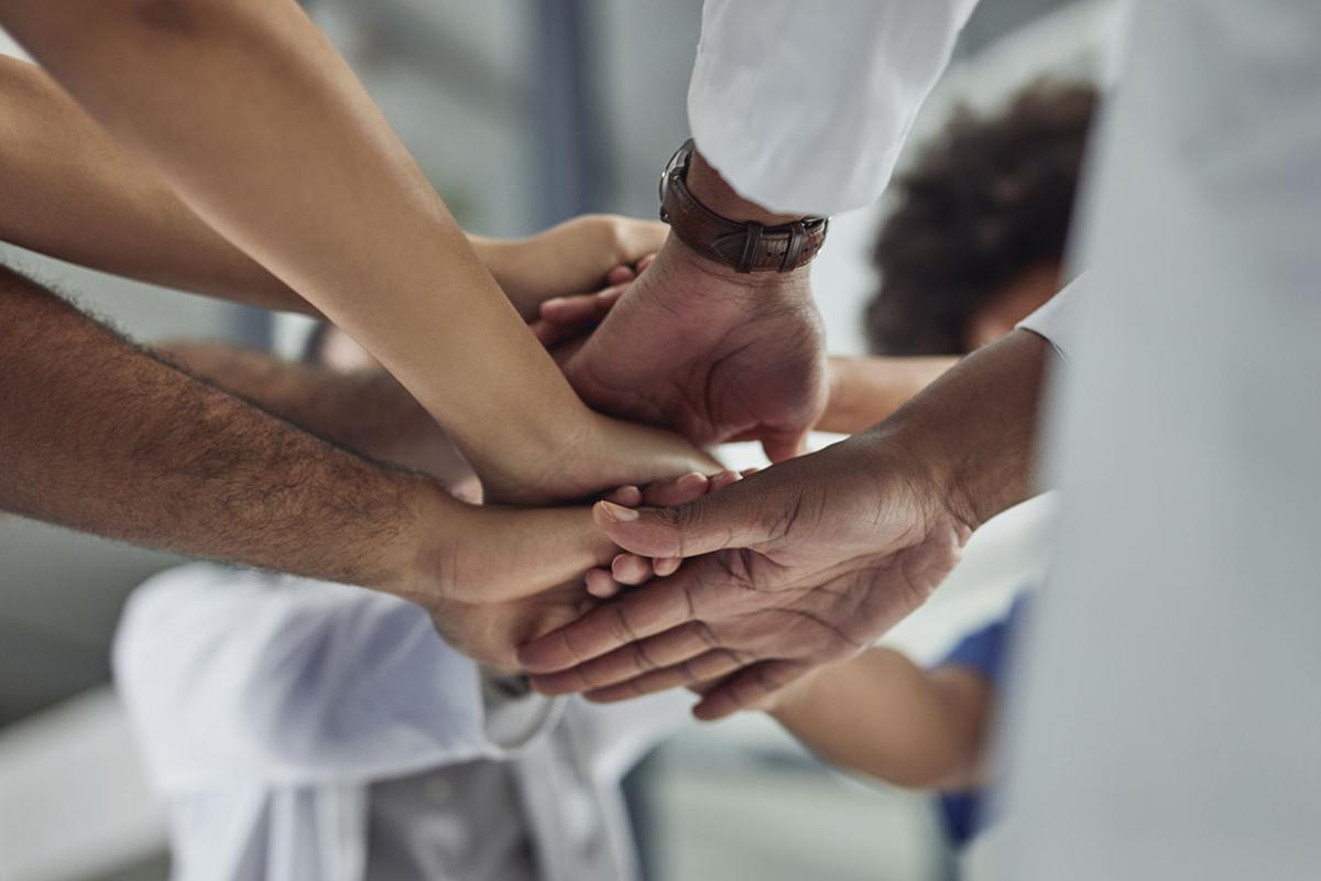 Health care team stacking hands