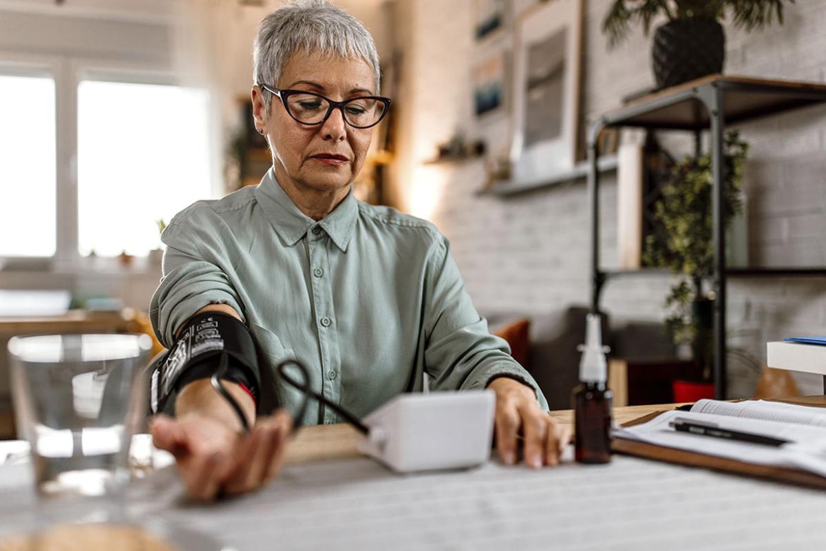 Senior patient checking blood pressure at home